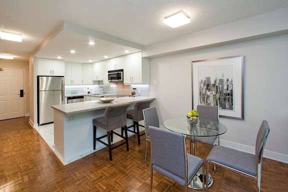 a kitchen and dining area with a glass table and chairs