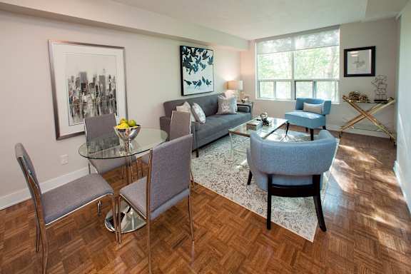 a living room with a couch and a table with chairs