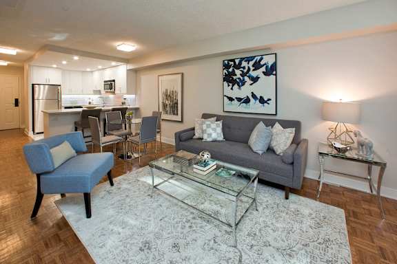a living room with a couch and a glass table