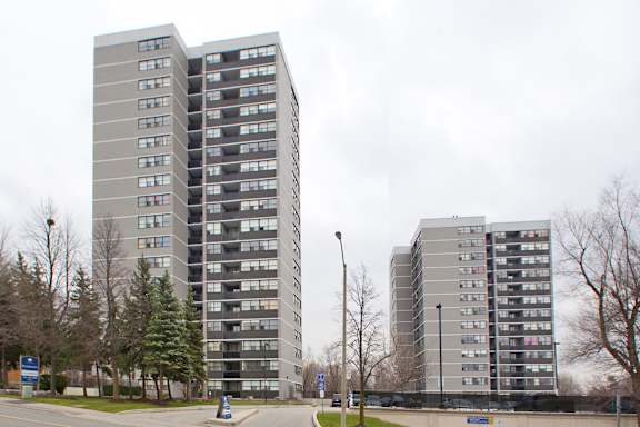 two high rise buildings on the side of a street