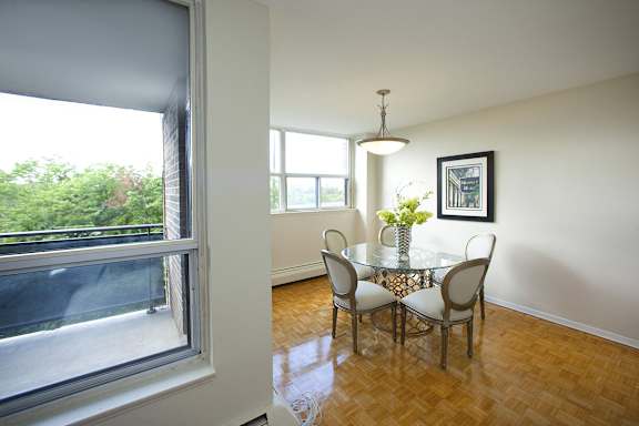 a dining room with a large window and a table with chairs