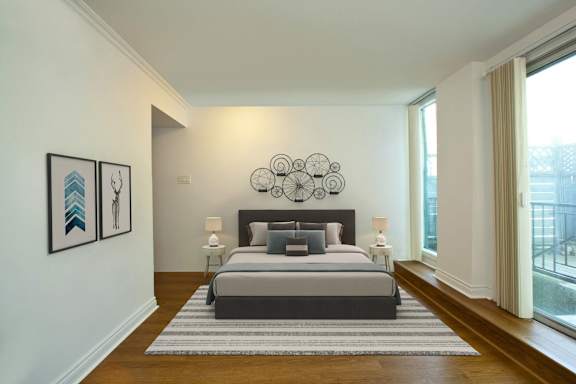 a bedroom with a bed and a large window