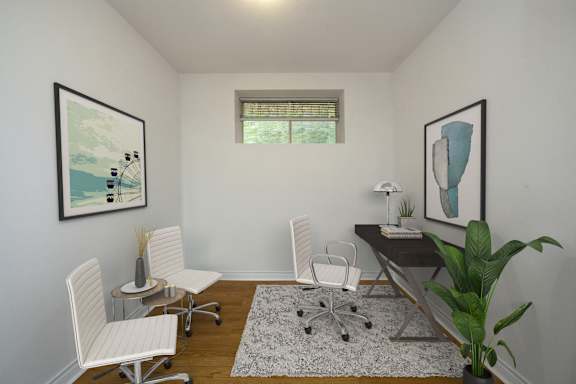 an office with white chairs and a desk and a window