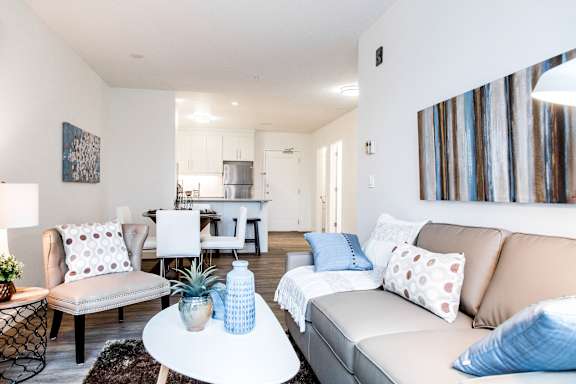 a living room with couches and chairs and a table