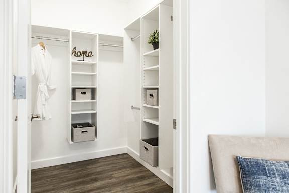 a bedroom with a closet and a white wardrobe