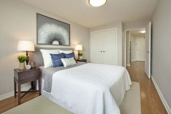 a bedroom with a large bed and a door to a hallway