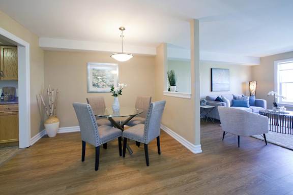 A dining room with a table set for four.
