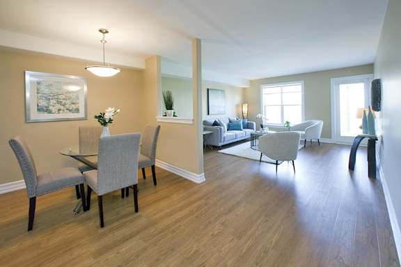 A dining room with a table and chairs.