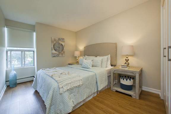 a bedroom with a large bed and a window