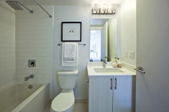 a white bathroom with a sink toilet and bath tub