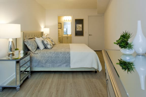 a bedroom with a bed and a dresser and a mirror