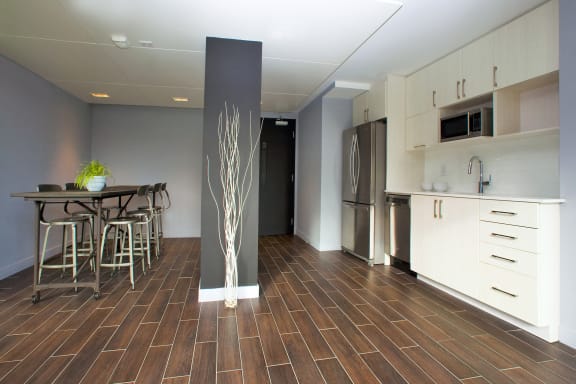 a kitchen and dining area with a table and chairs and a refrigerator