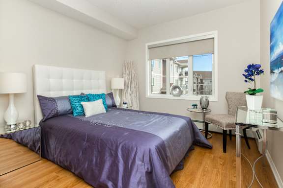 a bedroom with a large bed and a window
