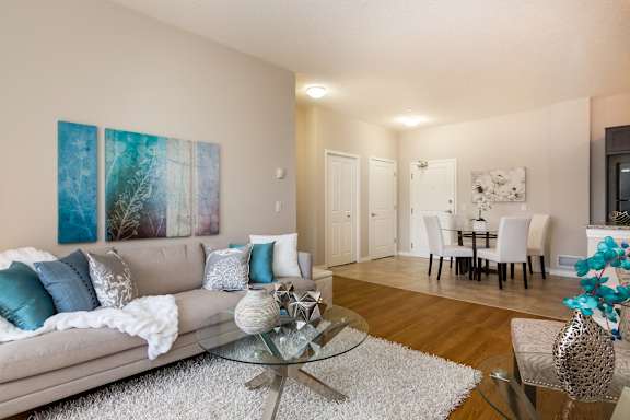 a living room and dining room with a couch and a glass table