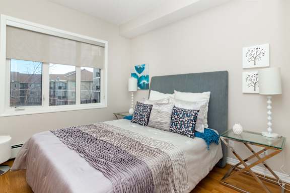 a bedroom with a bed and a large window