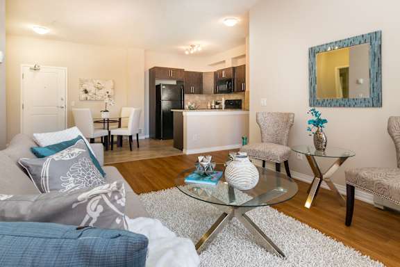 a living room with a couch and a glass table