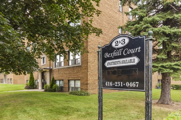 a sign in front of an apartment building