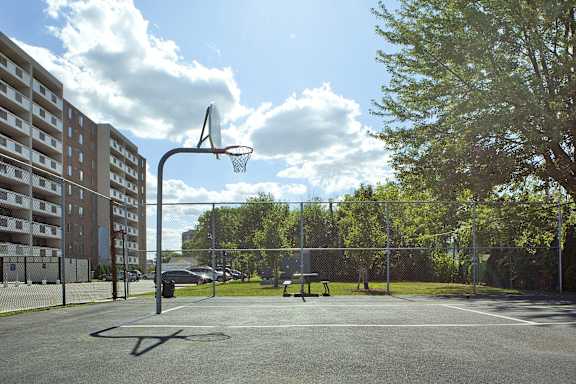 a basketball court in a park next to a building