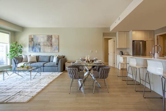 A modern dining room with a glass table and chairs.