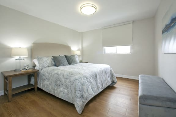 a bedroom with a bed and a couch and a window