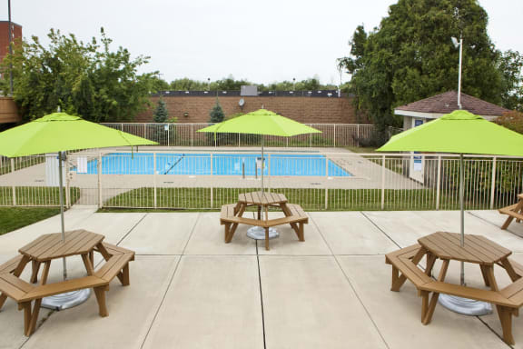 our apartments have a large patio with tables and umbrellas
