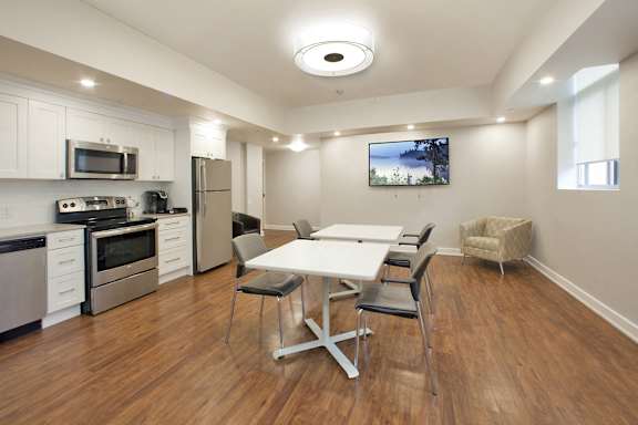 A modern kitchen with a dining table and chairs.