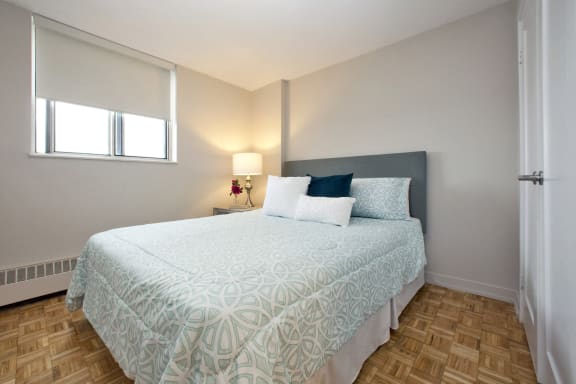 a bedroom with a bed and a window