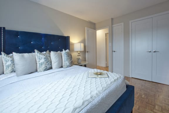 a bedroom with a large white bed and a blue headboard