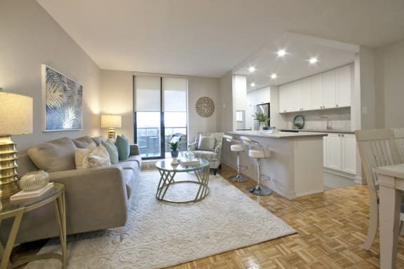 a living room and kitchen with a couch and a table