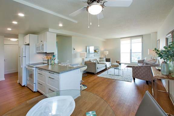 A modern kitchen with a dining area and a living room.