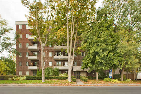 Apartment building with trees in front.