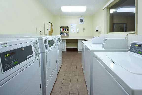 A row of washing machines in a laundromat.
