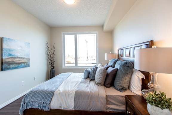 a bedroom with a large bed and a window