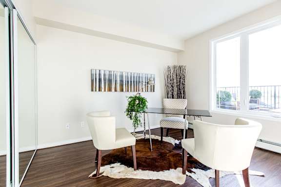 a living room with a table and chairs and a large window