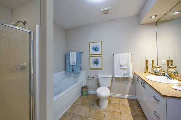 A bathroom with a toilet, sink, and bathtub.