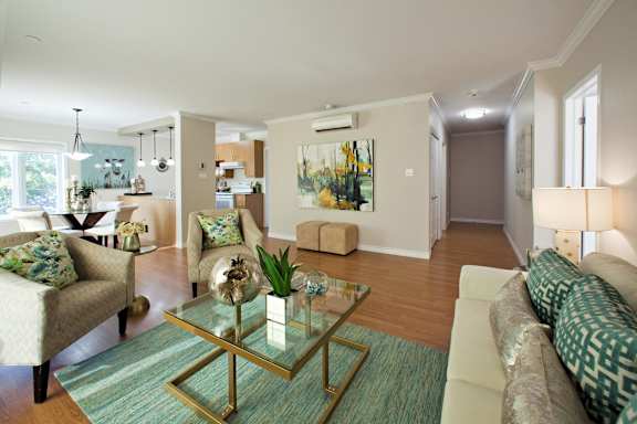 A living room with a glass coffee table and a couch.