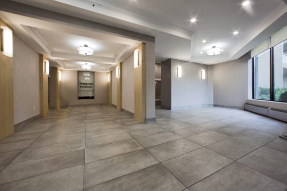 a hallway with large windows and a large tile floor