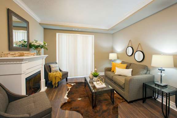 A living room with a fireplace, couch, and coffee table.