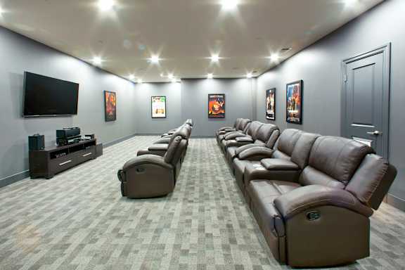 A row of brown recliner chairs are lined up in a room.