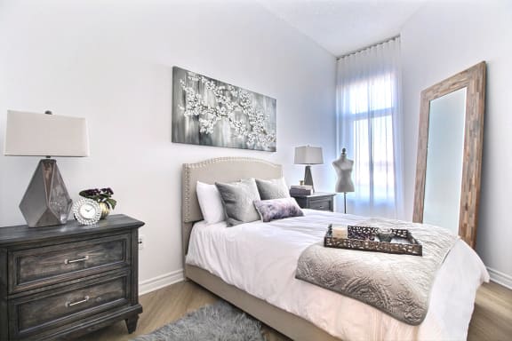a bedroom with a large bed and a mirror