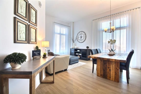 a living room and dining room with a table and chairs