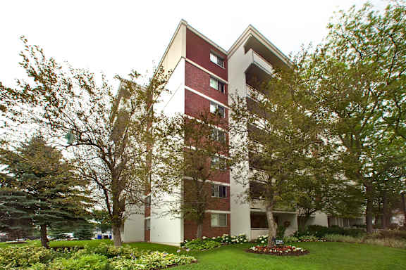 A red and white building with trees in front.