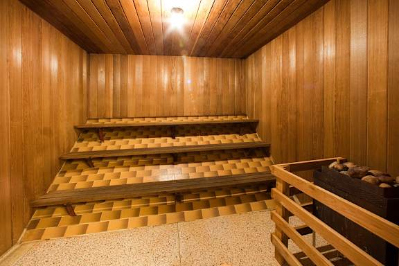 A wooden staircase with a checkered floor.