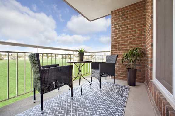 A patio with a table and chairs.