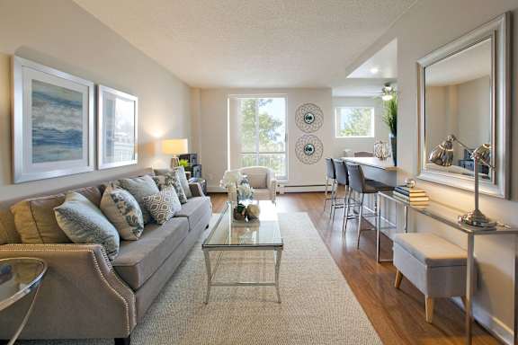 A living room with a couch, chairs, and a coffee table.