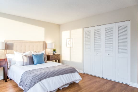 a bedroom with a large bed and white closet