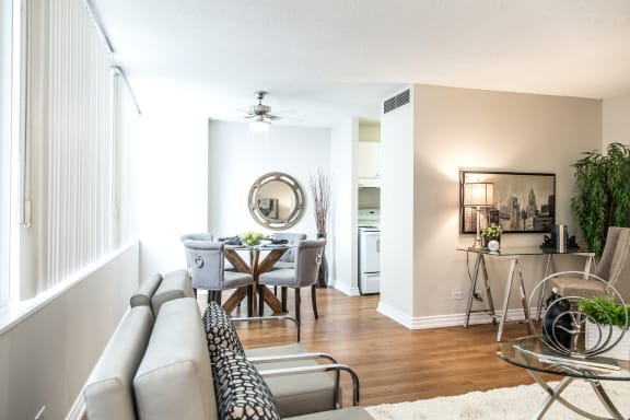a living room and dining room with a table and a couch