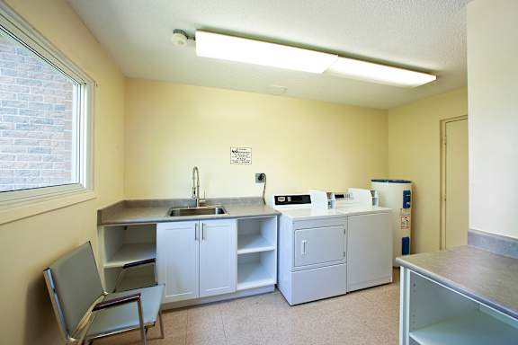 a kitchen with two counters and a sink and a refrigerator