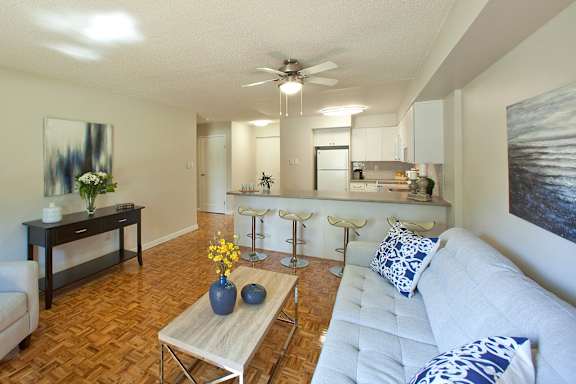 a living room and kitchen with a couch and a table