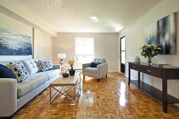 a living room with a couch and chairs and a table